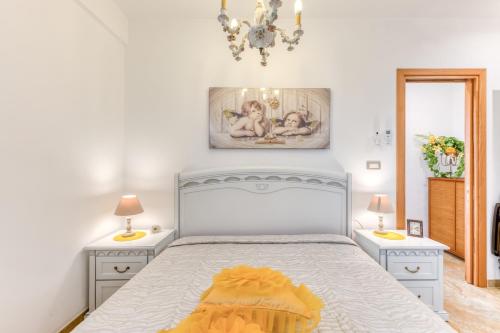 a bedroom with a white bed with two night stands at Il Girasole in Torre Vado