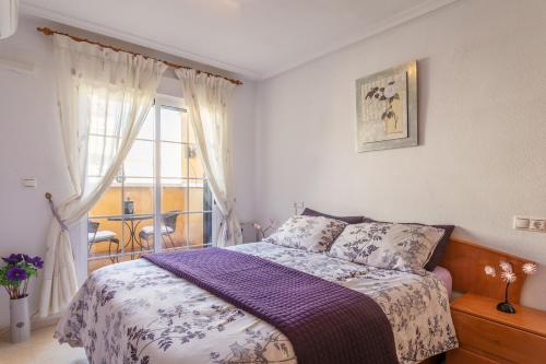 a bedroom with a bed and a window at Casa Susan in Torrevieja