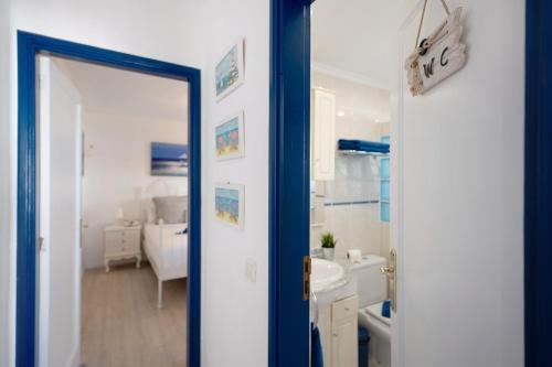 a bathroom with a tub and a sink and a mirror at Puerto Chico A in Playa Blanca