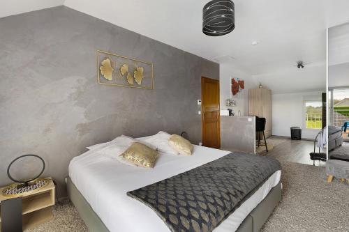 a bedroom with a large white bed in a room at Chambre D'hôtes Take-off - Chambre in Saint-Georges-sur-Cher