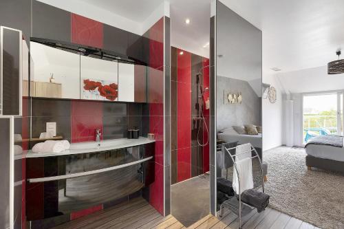 a bathroom with a sink and a shower in a room at Chambre D'hôtes Take-off - Chambre in Saint-Georges-sur-Cher
