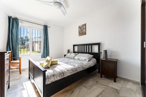 a bedroom with a bed and a large window at Superbly situated Vistamar in Mijas Costa