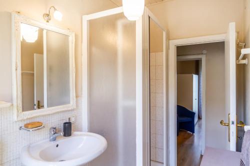 a bathroom with a sink and a mirror at Appartamento il corso in Roccastrada