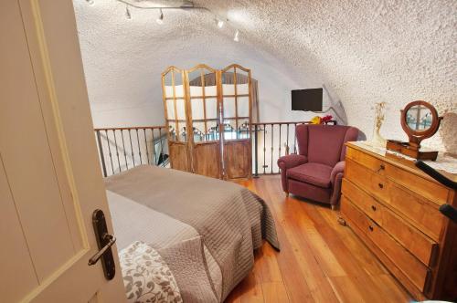 a bedroom with a bed and a chair and a dresser at Casa Al Molo in Musso