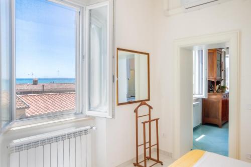 a room with a window with a view of the ocean at Appartamenti Remota in Castiglione della Pescaia