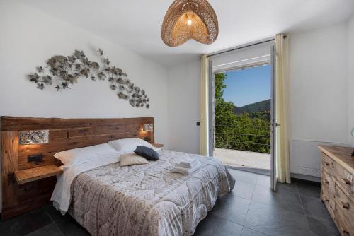 a bedroom with a large bed and a large window at Villa Lice - Sciacchetrà in Casarza Ligure