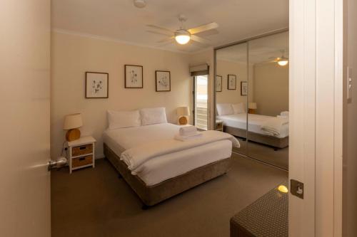 a bedroom with a large bed and a mirror at River Vista at Aruma in Walker Flat