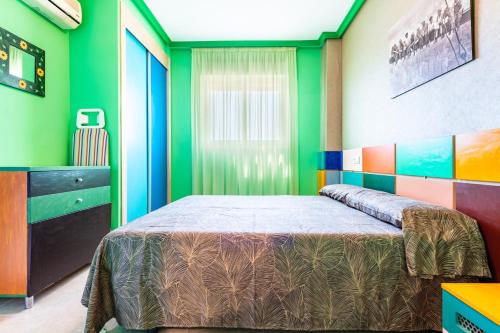 a bedroom with a bed and colorful walls at Neptuno in Oropesa del Mar
