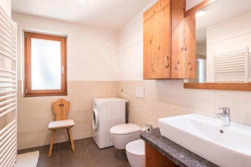 a bathroom with a white sink and a toilet at Thalerhof App Melisse in Feldthurns