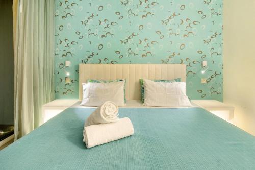a bedroom with a blue bed with a chair on it at Dfm Happy Days A - Funchal in Funchal