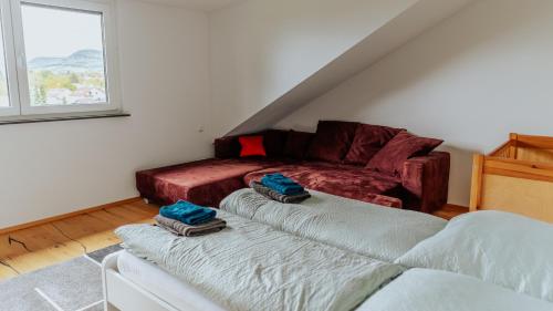 a living room with two beds and a couch at Schöne Relaxunterkunft-barrierefrei in Mössingen