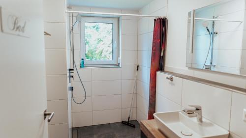 a bathroom with a sink and a shower at Schöne Relaxunterkunft-barrierefrei in Mössingen
