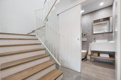 a staircase in a bathroom with a sink and a toilet at Casa Helena in Ferragudo