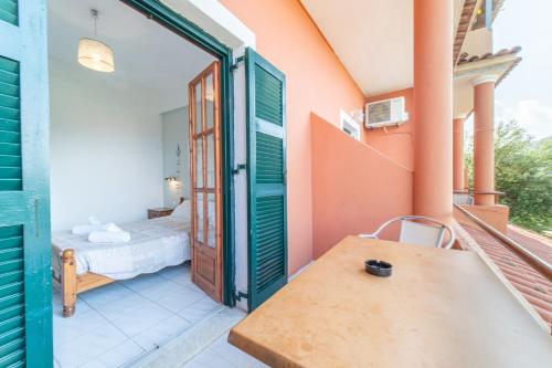 a room with a bed and a open door at Arianna apartment 10 in Paleokastritsa
