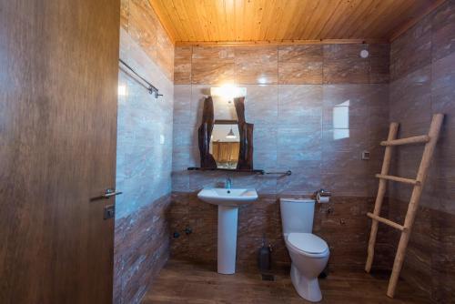 a bathroom with a toilet and a sink at Mirage Arillas Villa Apartment in Arillas