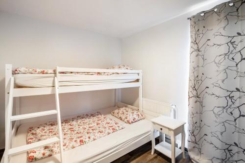 a room with two bunk beds and a curtain at Ferienhaus im Harz in Harzgerode