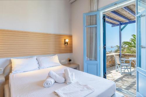 a bedroom with a bed with towels on it at La Casa Tinos 22 in Tinos