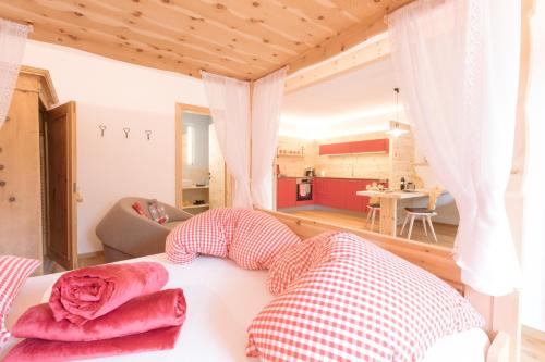 a room with a bed with pillows on it at Ferienwohnung Wold Wieserhof in Aldino