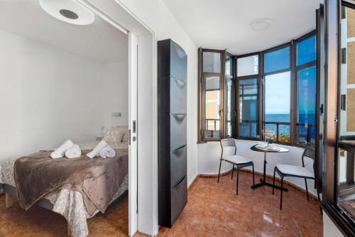 a bedroom with a bed and a table with chairs at Tamaragua in Candelaria