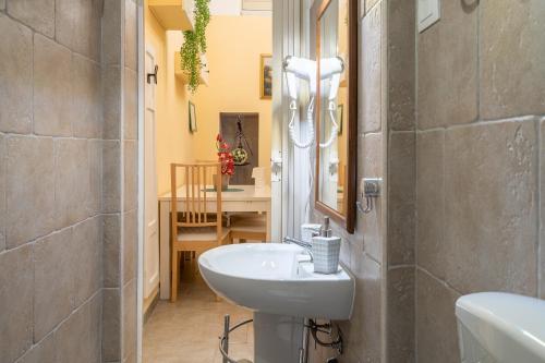 a bathroom with a sink and a toilet in a room at Pomona Noto in Noto