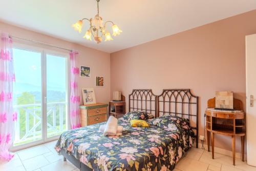 a child laying on a bed in a bedroom with a window at Gite Gousseau in Buzy