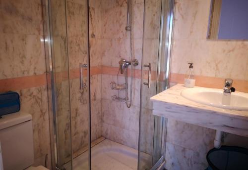 a bathroom with a shower and a sink at Casa Danca Cabopino in Marbella