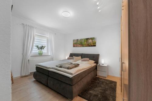 a bedroom with a bed and a window at Bella Casa in Sankt Wendel