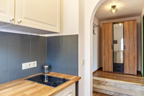 a kitchen with a sink and a counter top at Aschaubichl - Wohnung Silberdistel in Grainau
