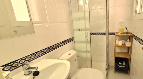 a bathroom with a toilet and a sink and a shower at La Cala Apartment in La Cala de Mijas