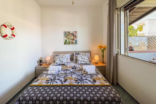 a bedroom with a bed and a window at White Sand Private Villa in Torre Squillace