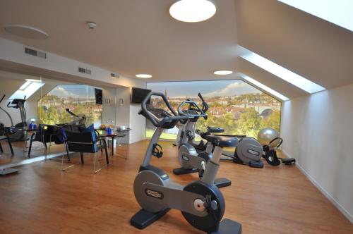 a gym with exercise bikes in a room with a view at Hotel Bären am Bundesplatz in Bern