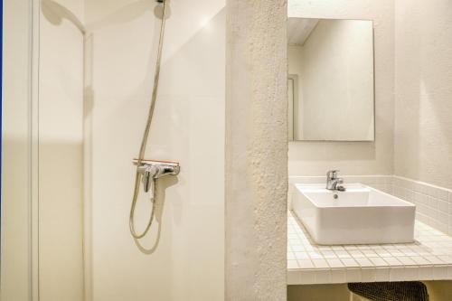 a white bathroom with a sink and a mirror at Apartamento Bajo 3 in Begur