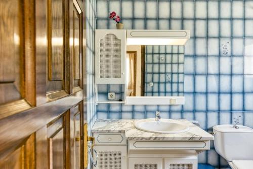a bathroom with a sink and a mirror at Casa Saguer in L'Escala