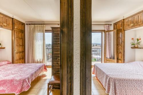 a bedroom with two beds and a window at Casa Saguer in L'Escala