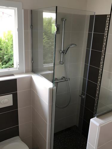 a bathroom with a shower with a glass door at Maison Amalur in Arcangues