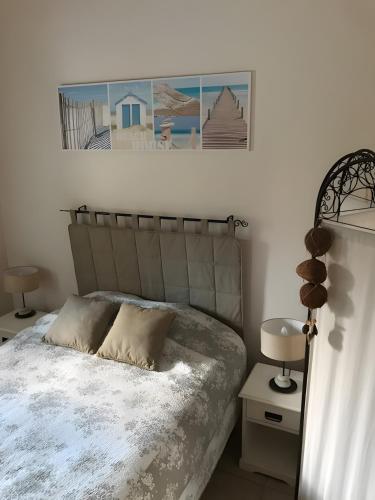 a bedroom with a bed and two tables with lamps at Maison Amalur in Arcangues