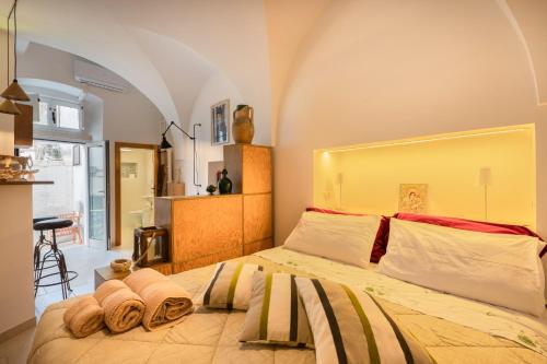 a bedroom with a large bed with towels on it at Casa Agata Cisternino in Cisternino