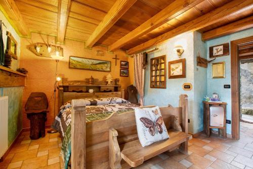 a bedroom with a bed in a room with wooden ceilings at Affittacamere Saint-Salod in Charvensod