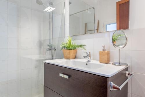 a bathroom with a sink and a mirror at Es Llimoner in Sóller