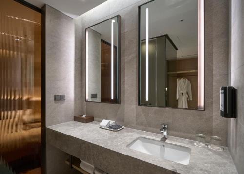a bathroom with a sink and a mirror at Mayfield Hotel Seoul in Seoul