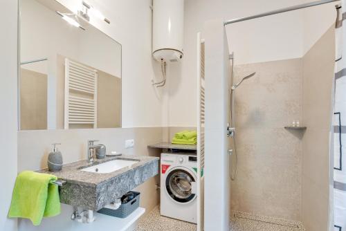 a bathroom with a sink and a washing machine at Ferienwohnung Daniela in Merano
