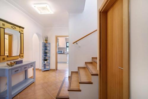 a bathroom with a staircase and a sink and a mirror at Villa Formosa in Almancil