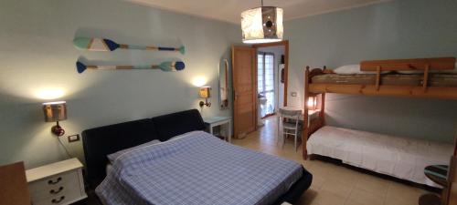 a bedroom with a bed and a bunk bed at Podere Le Palme in Castiadas
