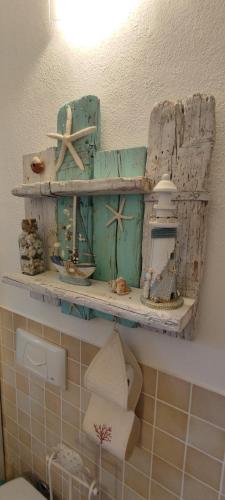 a bathroom with a shelf withautical items on it at Podere Le Palme in Castiadas