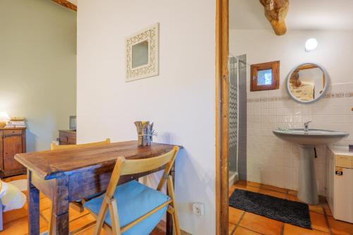a bathroom with a wooden table and a sink at Chambre La Louve in Banne