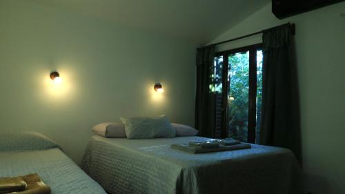 a bedroom with two beds and a window at El Aromito in Jesús María