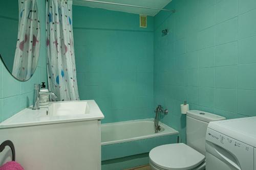 a bathroom with a sink and a toilet and a tub at Villa Amanda in Playa del Cura
