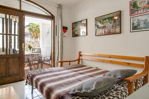 a bedroom with a bed in a room with a window at Villa Amanda in Playa del Cura