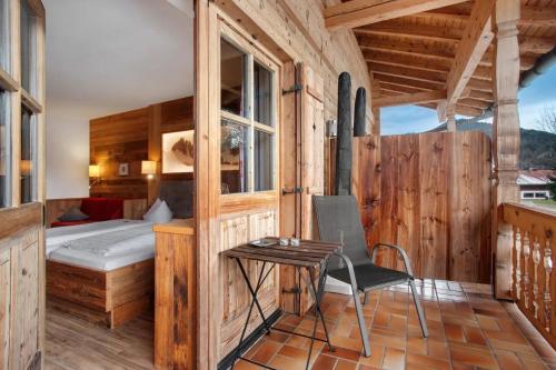 a bedroom with a bed and a table in a room at Gästehaus Panorama - Appartement 3 in Reit im Winkl
