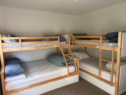 a room with three bunk beds in a room at Eunoia at Smiths in Smiths Beach